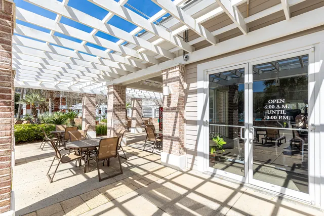 a view of a porch with a floor to ceiling window next to a yard
