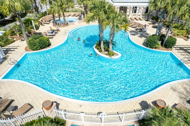 a view of a big yard with table and chairs under an umbrella