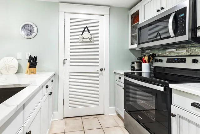 a kitchen with stainless steel appliances granite countertop a sink and a stove