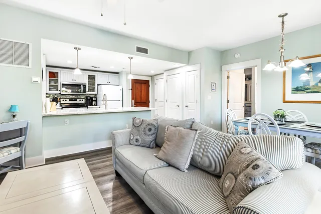a living room with furniture kitchen and a chandelier