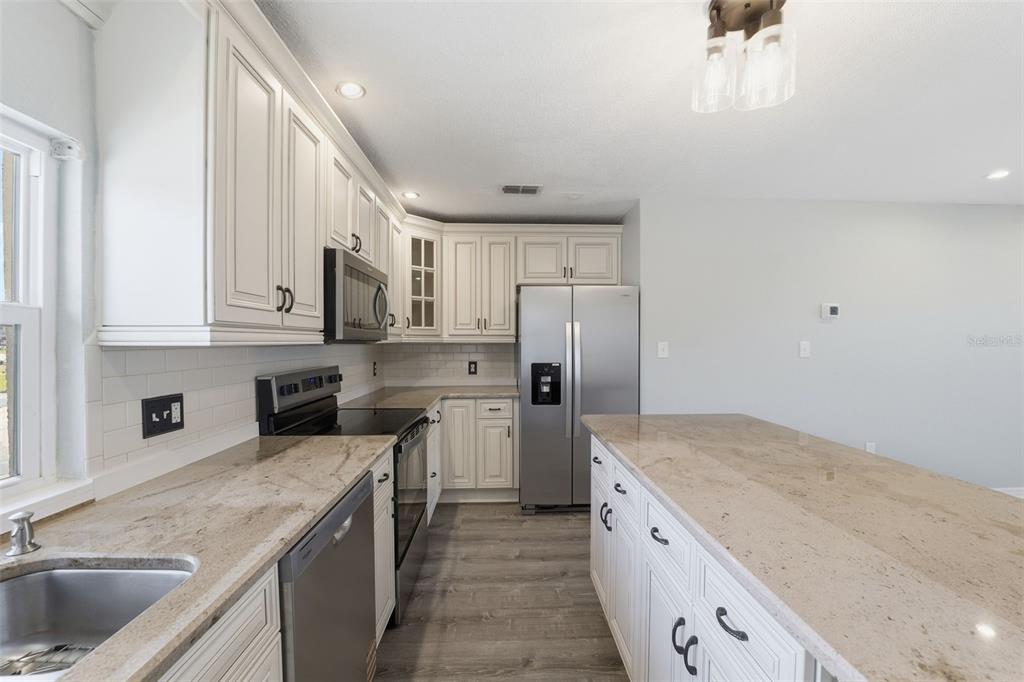 5153 Turquoise Lane, Unit 102 New Port Richey, FL 34652 - Photo 11 of 29 a kitchen with a sink stove and refrigerator