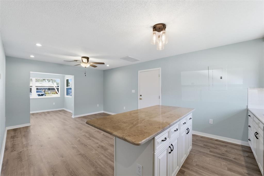 5153 Turquoise Lane, Unit 102 New Port Richey, FL 34652 - Photo 13 of 29 a kitchen with a stove and chandelier