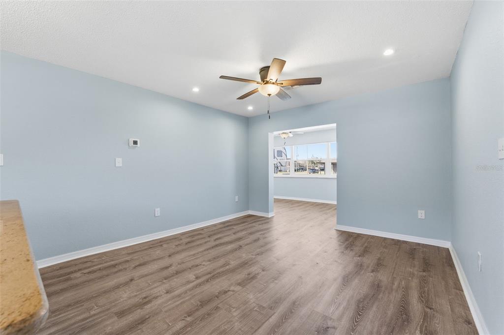 5153 Turquoise Lane, Unit 102 New Port Richey, FL 34652 - Photo 15 of 29 wooden floor in an empty room with a window