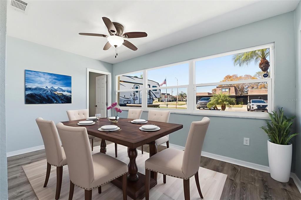 5153 Turquoise Lane, Unit 102 New Port Richey, FL 34652 - Photo 18 of 29 a dining room with furniture and window