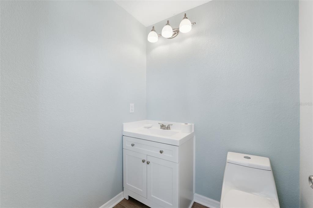 5153 Turquoise Lane, Unit 102 New Port Richey, FL 34652 - Photo 20 of 29 a bathroom with a sink a light fixture and toilet