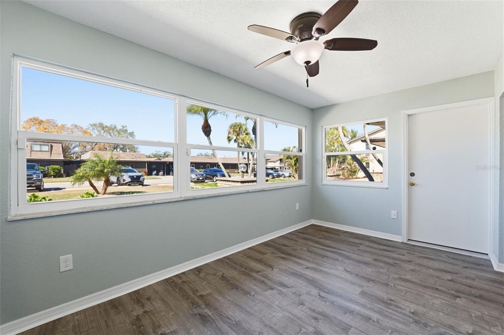 5153 Turquoise Lane, Unit 102 New Port Richey, FL 34652 - Photo 21 of 29 a view of a kitchen with wooden floor and a ceiling fan