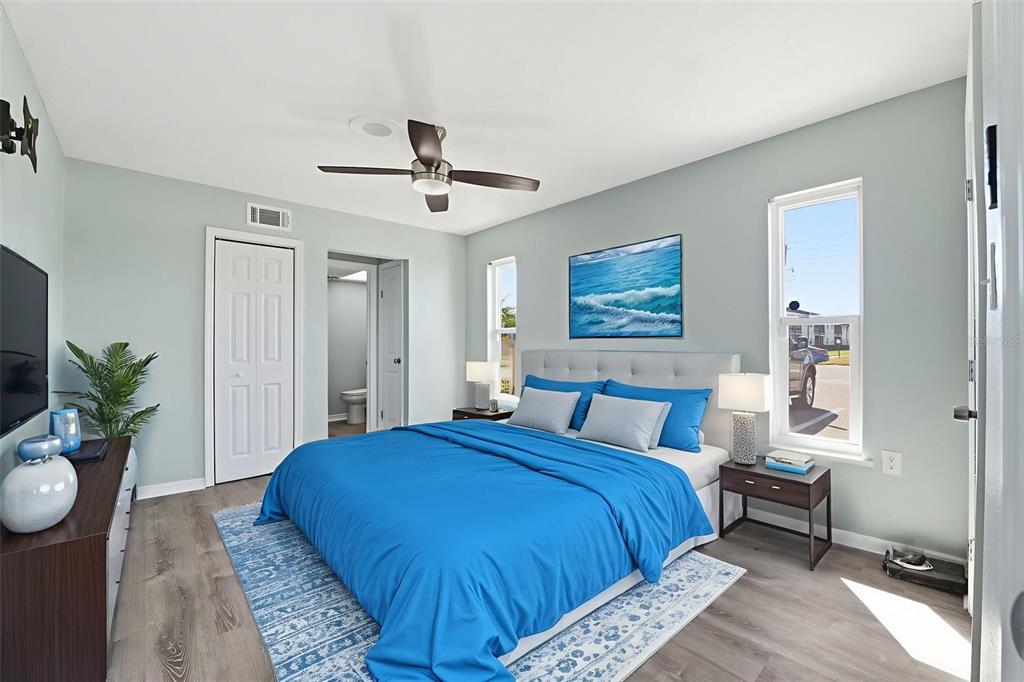 5153 Turquoise Lane, Unit 102 New Port Richey, FL 34652 - Photo 24 of 29 a bedroom with a large bed and a chandelier