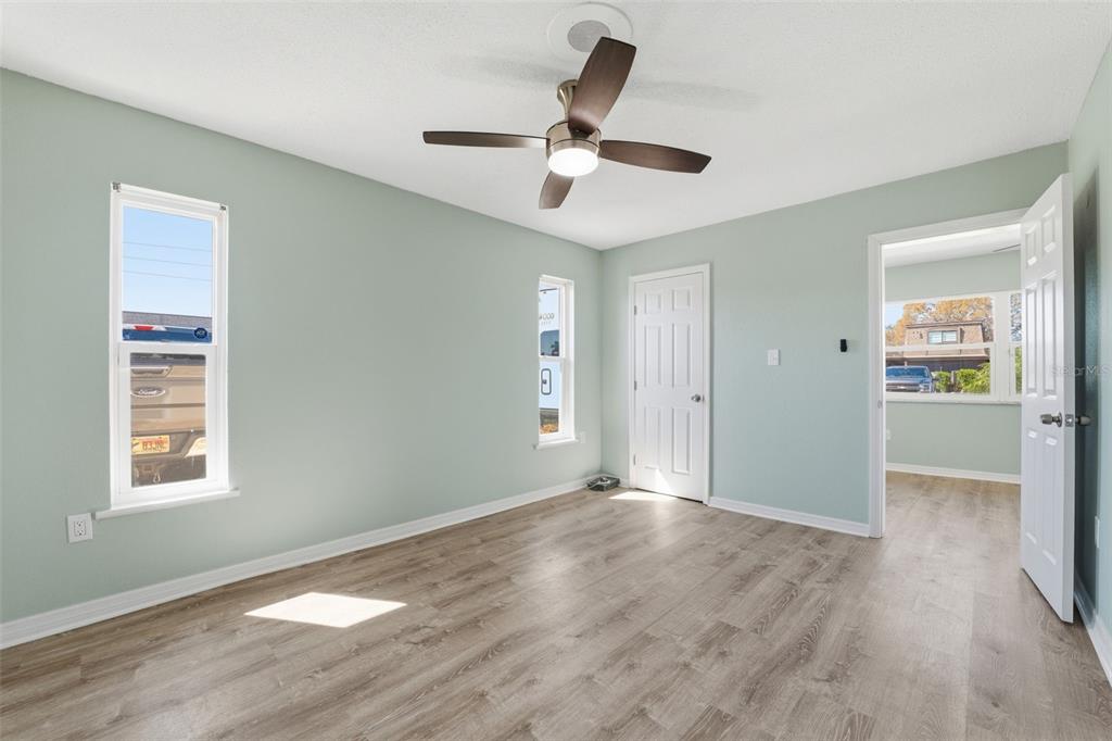 5153 Turquoise Lane, Unit 102 New Port Richey, FL 34652 - Photo 25 of 29 a view of an empty room with wooden floor and a window