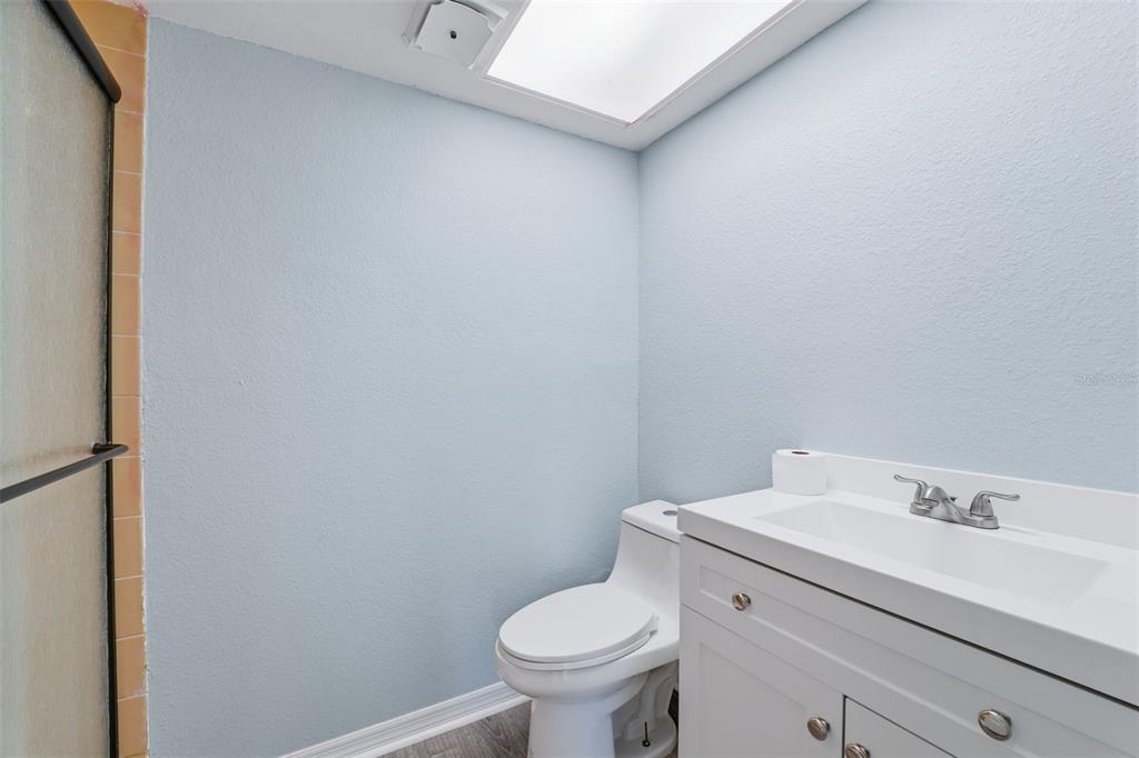 5153 Turquoise Lane, Unit 102 New Port Richey, FL 34652 - Photo 26 of 29 a bathroom with a sink a toilet and a mirror
