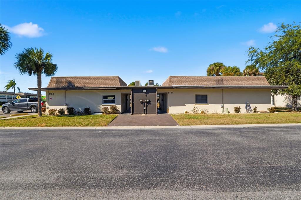5153 Turquoise Lane, Unit 102 New Port Richey, FL 34652 - Photo 28 of 29 a view of swimming pool with a lawn chairs under an umbrella