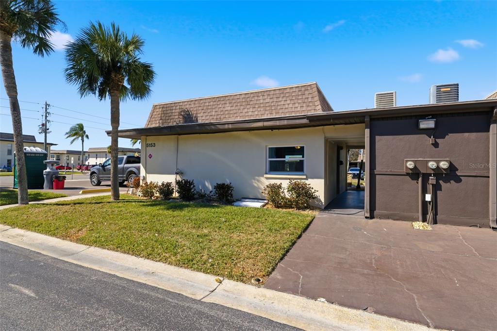 5153 Turquoise Lane, Unit 102 New Port Richey, FL 34652 - Photo 29 of 29 a front view of a house with garden