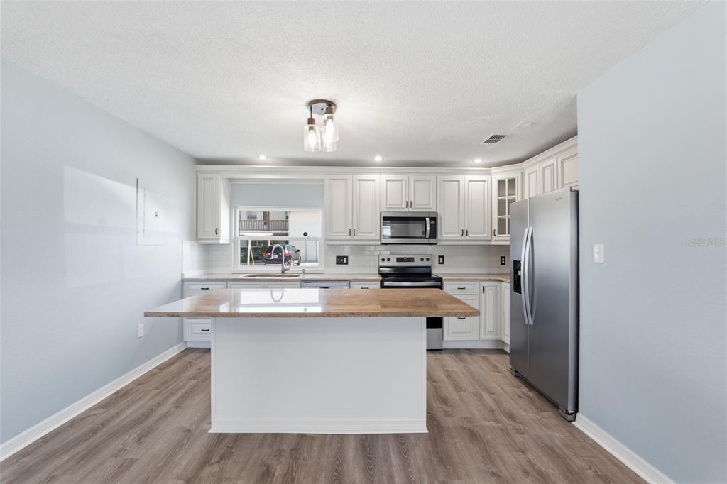 5153 Turquoise Lane, Unit 102 New Port Richey, FL 34652 - Photo 8 of 29 a kitchen with stainless steel appliances a sink and a refrigerator