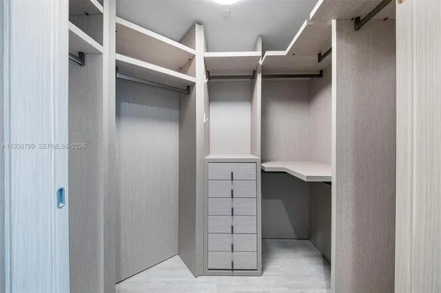 a view of a room with wooden floor and window