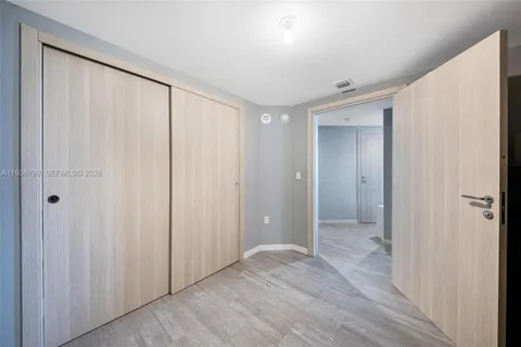 a bathroom with a sink and mirror with bathtub