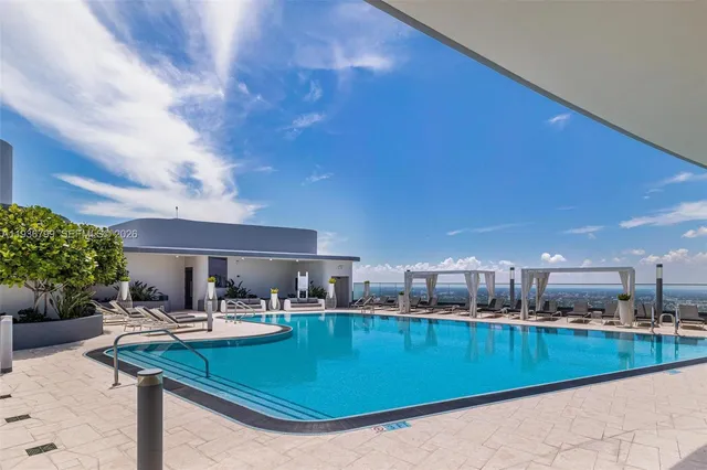 a view of a livingroom with furniture and a gym cycle
