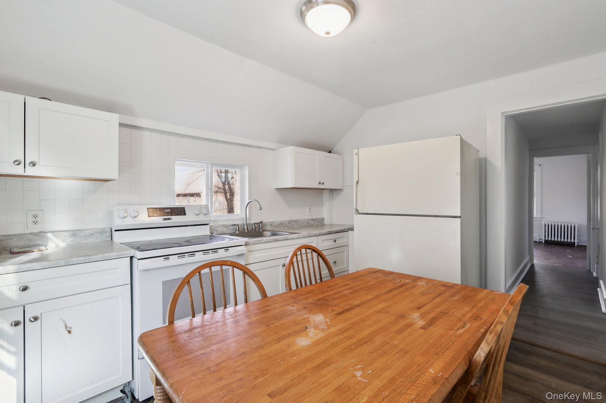 114 Spring Street South Salem, NY 10590 - Photo 7 of 13 a kitchen with stainless steel appliances granite countertop a kitchen island a stove a refrigerator a sink a dining table and chairs