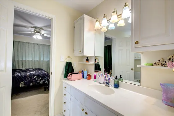 a en suite bathroom with a double vanity sink and a mirror