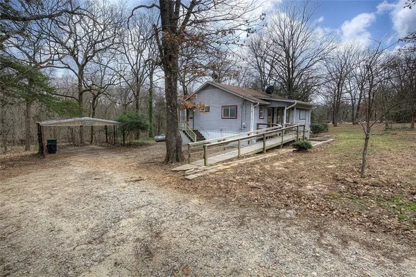 a white house that has a tree in front of it