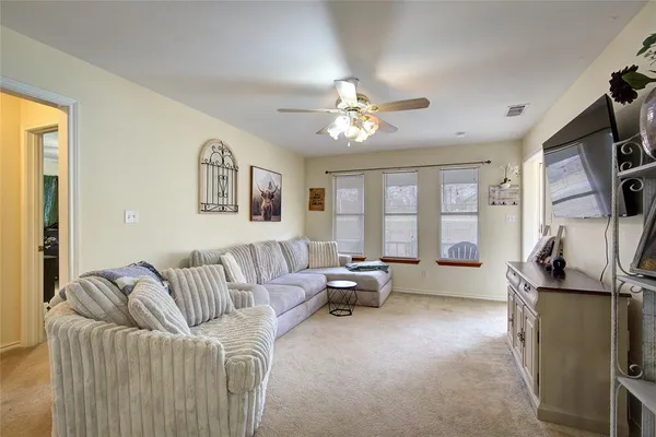 a living room with furniture fireplace and a flat screen tv