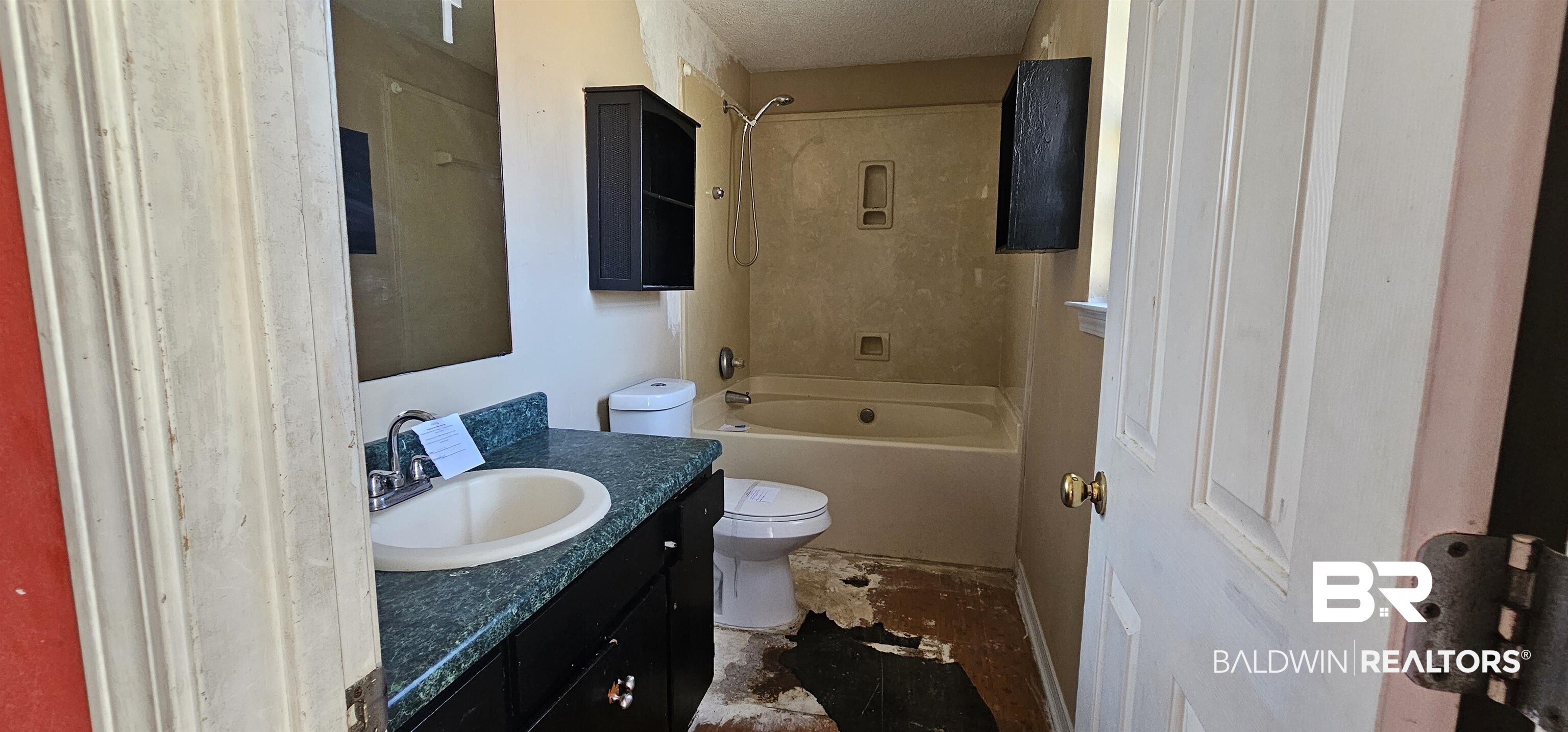 151 Bullard Street Atmore, AL 36502 - Photo 14 of 38 Full bathroom featuring vanity, shower / bathtub combination, and a textured ceiling