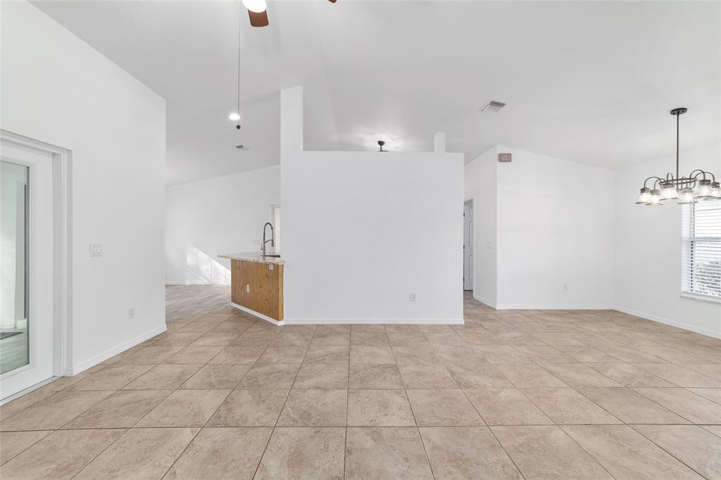 13688 Southwest 113th Lane Dunnellon, FL 34432 - Photo 15 of 70 a view of a big room with windows and chandelier fan