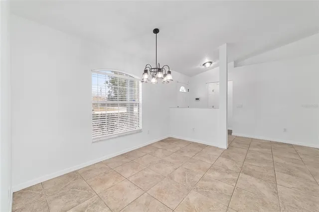 a view of a kitchen with wooden floor and a window