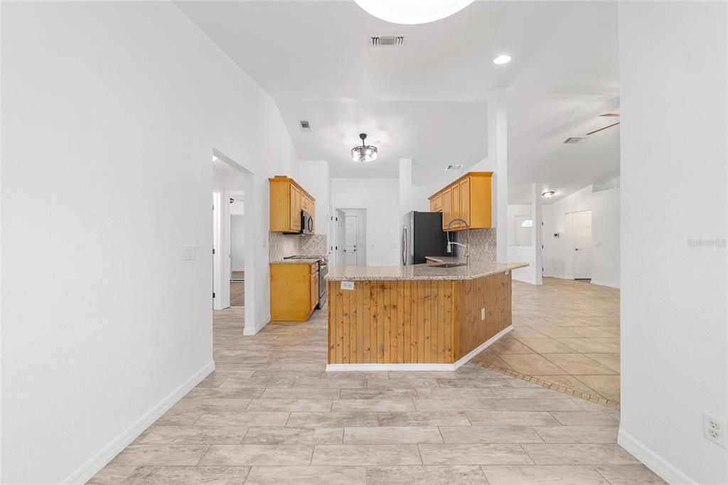 13688 Southwest 113th Lane Dunnellon, FL 34432 - Photo 25 of 70 a view of a kitchen with a sink and a refrigerator