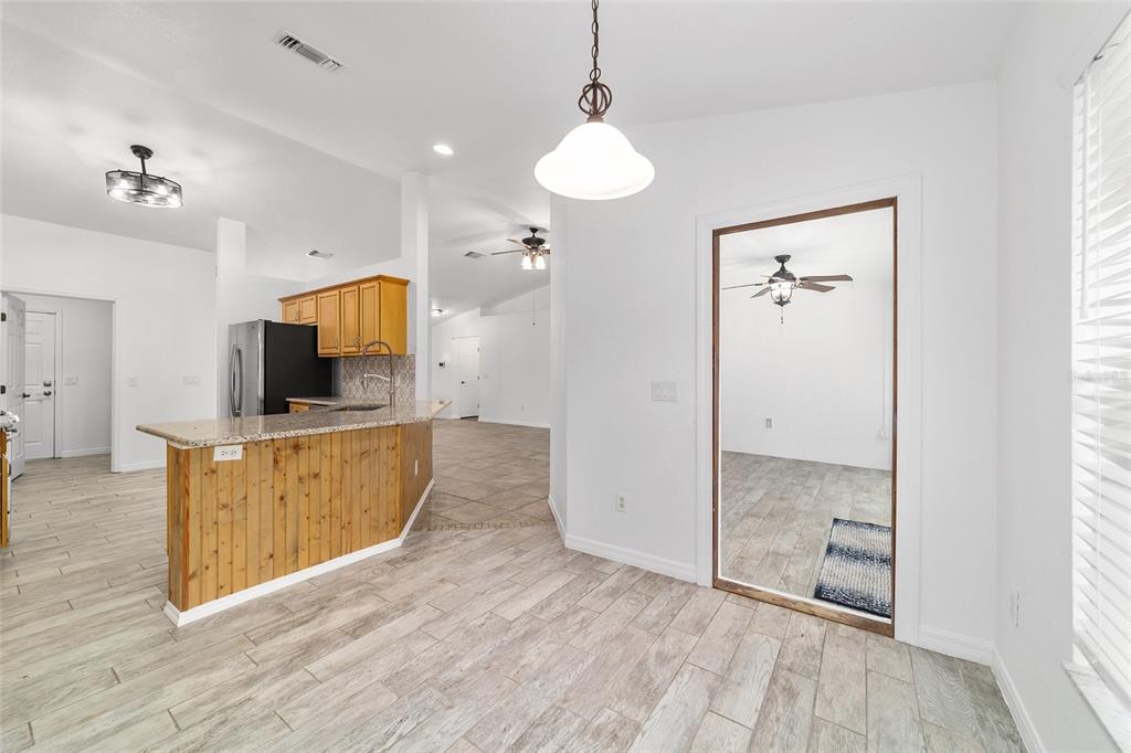 13688 Southwest 113th Lane Dunnellon, FL 34432 - Photo 26 of 70 a view of a kitchen with wooden floor and a window