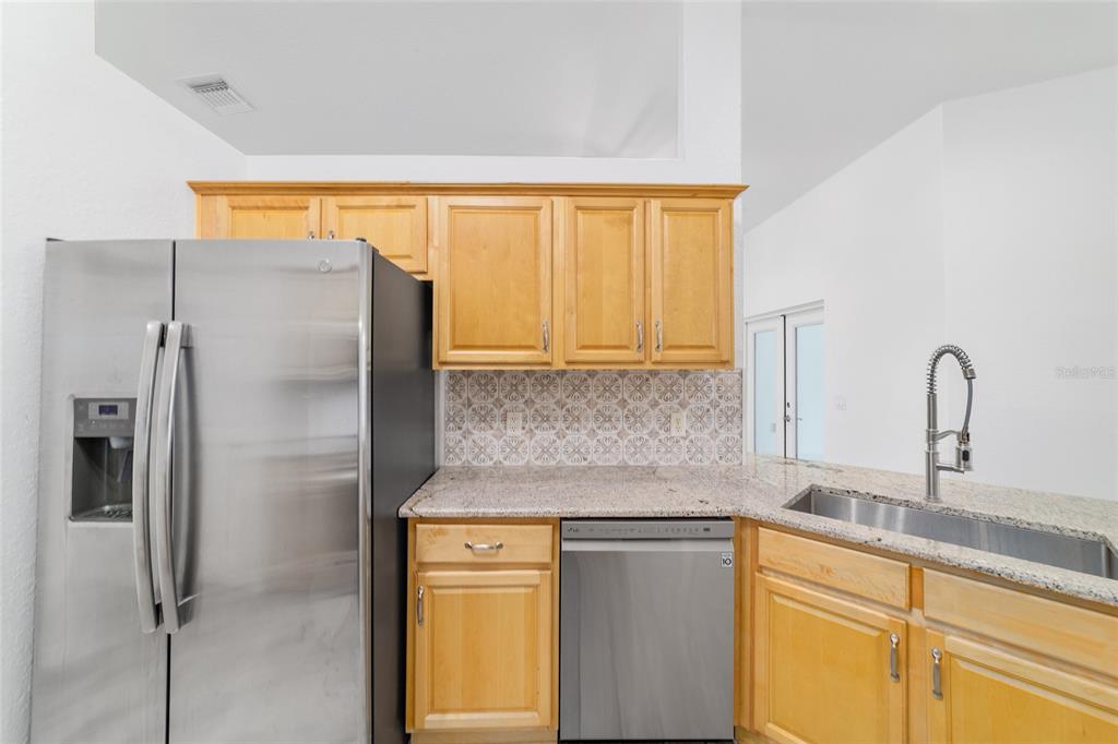 13688 Southwest 113th Lane Dunnellon, FL 34432 - Photo 31 of 70 a kitchen with stainless steel appliances granite countertop a refrigerator and a sink