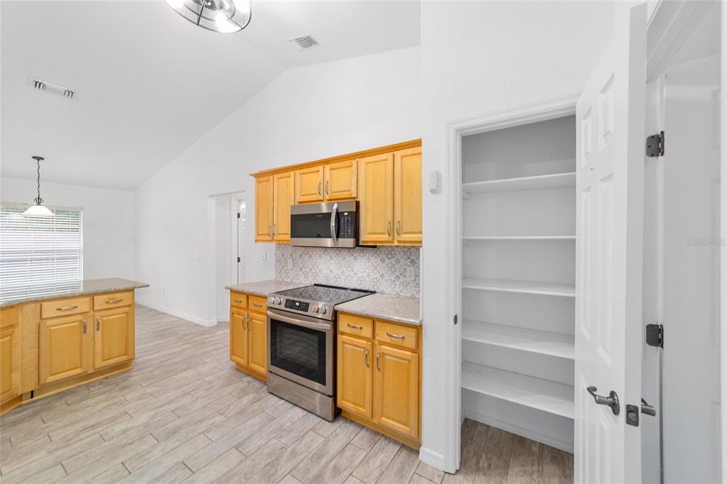 13688 Southwest 113th Lane Dunnellon, FL 34432 - Photo 33 of 70 a kitchen with stainless steel appliances granite countertop a stove and a sink