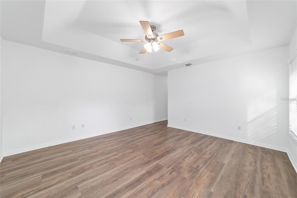 13688 Southwest 113th Lane Dunnellon, FL 34432 - Photo 38 of 70 a view of a room with wooden floor and a ceiling fan