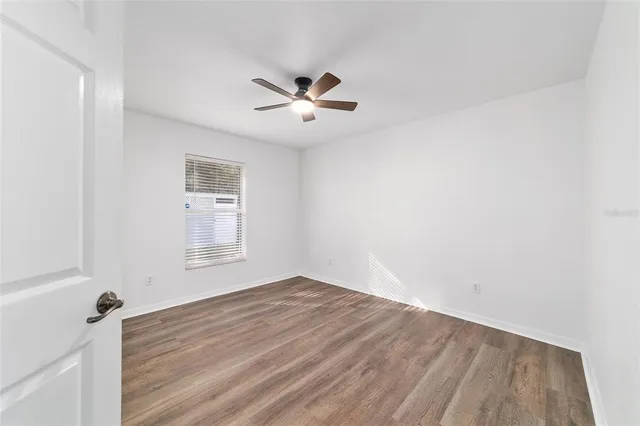 a view of a big room with a ceiling fan