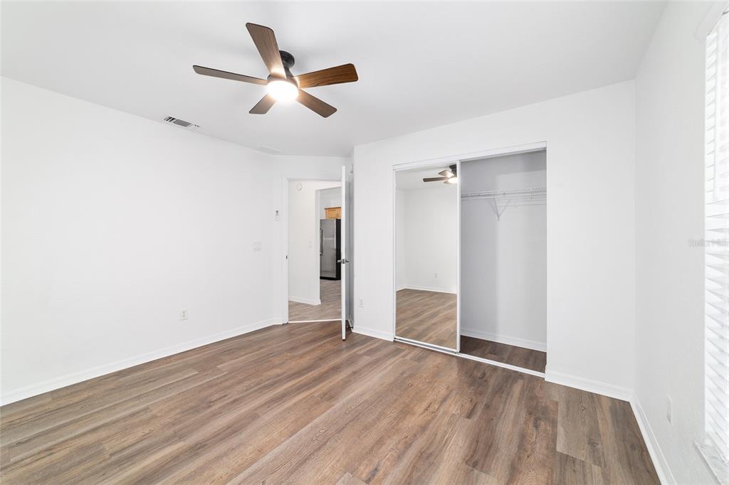 13688 Southwest 113th Lane Dunnellon, FL 34432 - Photo 47 of 70 an empty room with wooden floor and a ceiling fan