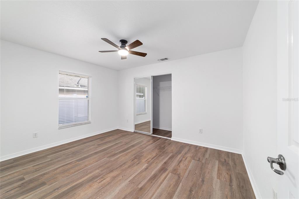 13688 Southwest 113th Lane Dunnellon, FL 34432 - Photo 49 of 70 a view of empty room with wooden floor and fan