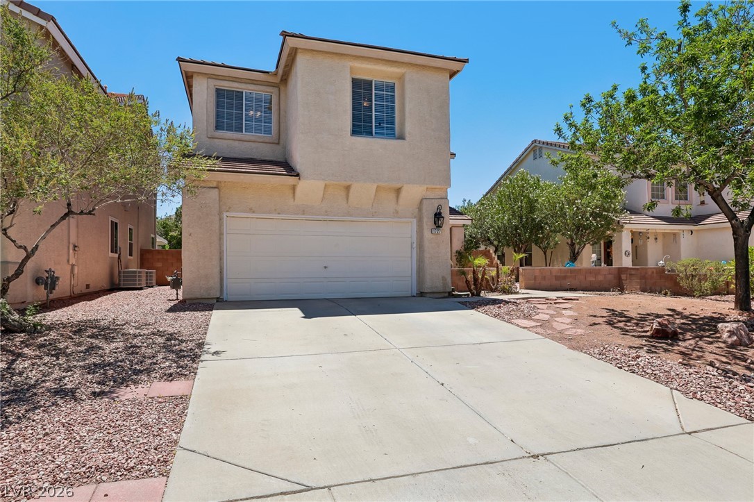 1727 Millstream Way Henderson, NV 89074 - Photo 6 of 46 A welcoming facade with a spacious driveway, integrated garage, and subtle landscaping.