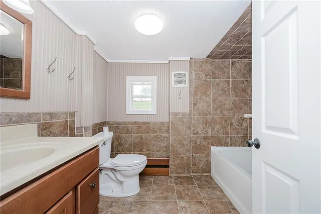 a bathroom with a sink a toilet and bathtub