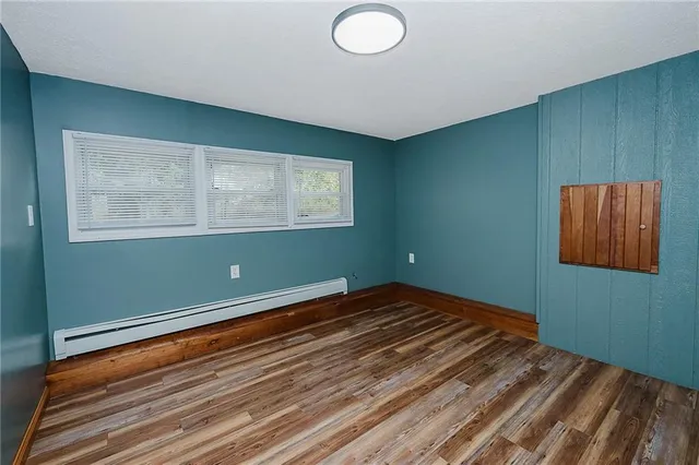 a view of a room with wooden floor and windows