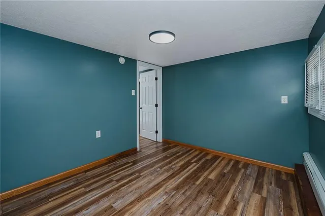 a view of room with wooden floor