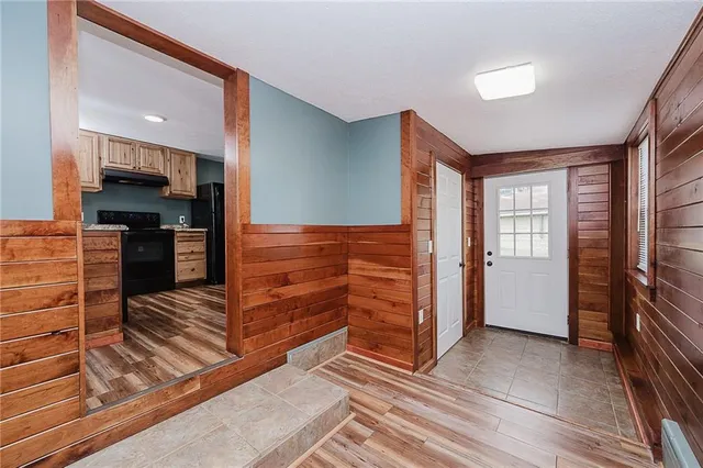 a view of kitchen with wooden floor and electronic appliances