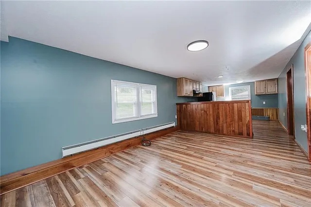 a view of a livingroom with wooden floor and window