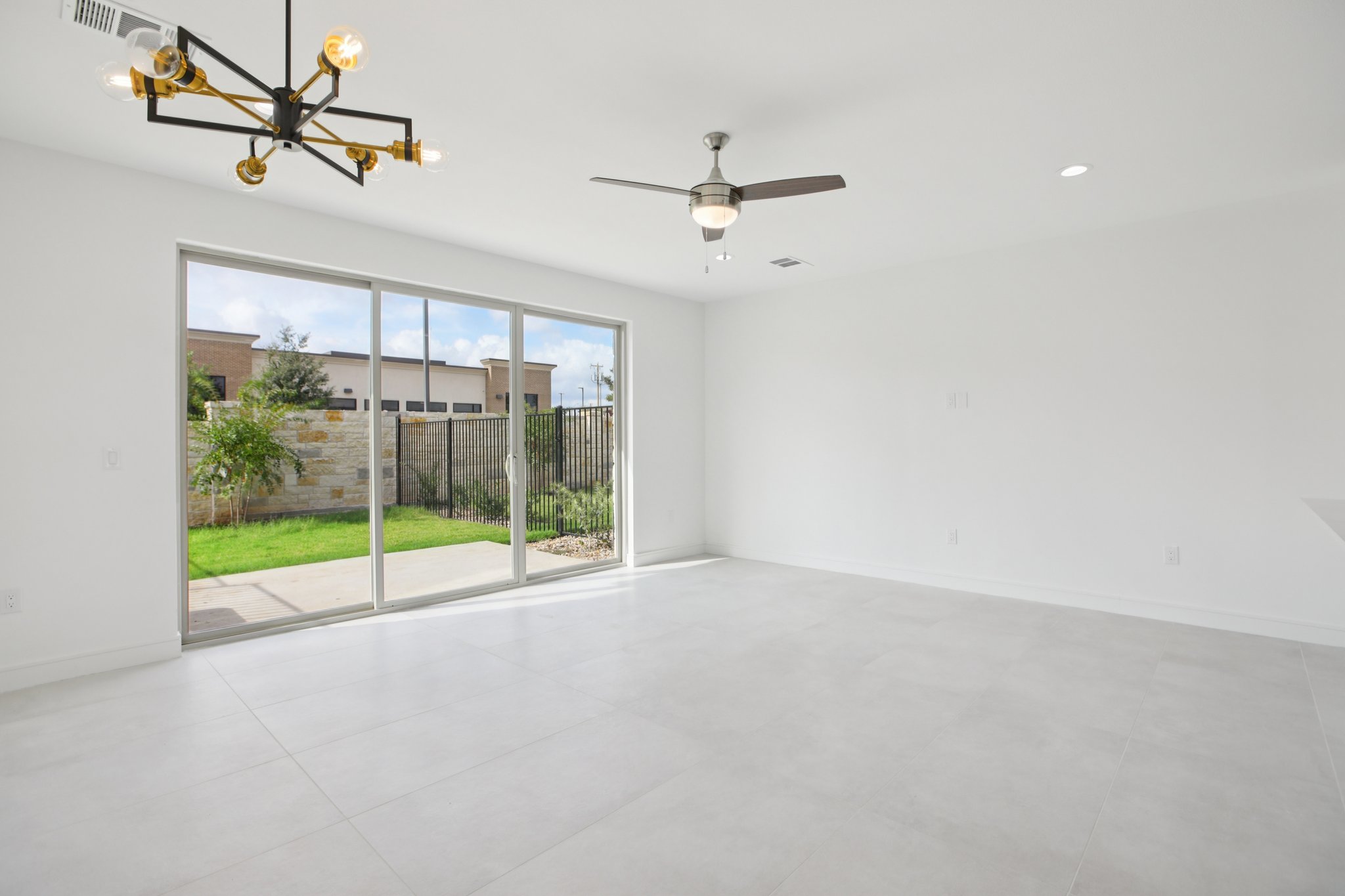 202 Tesla Circle Austin, TX 78681 - Photo 9 of 35 Unfurnished room featuring suspended lighting and ceiling fan