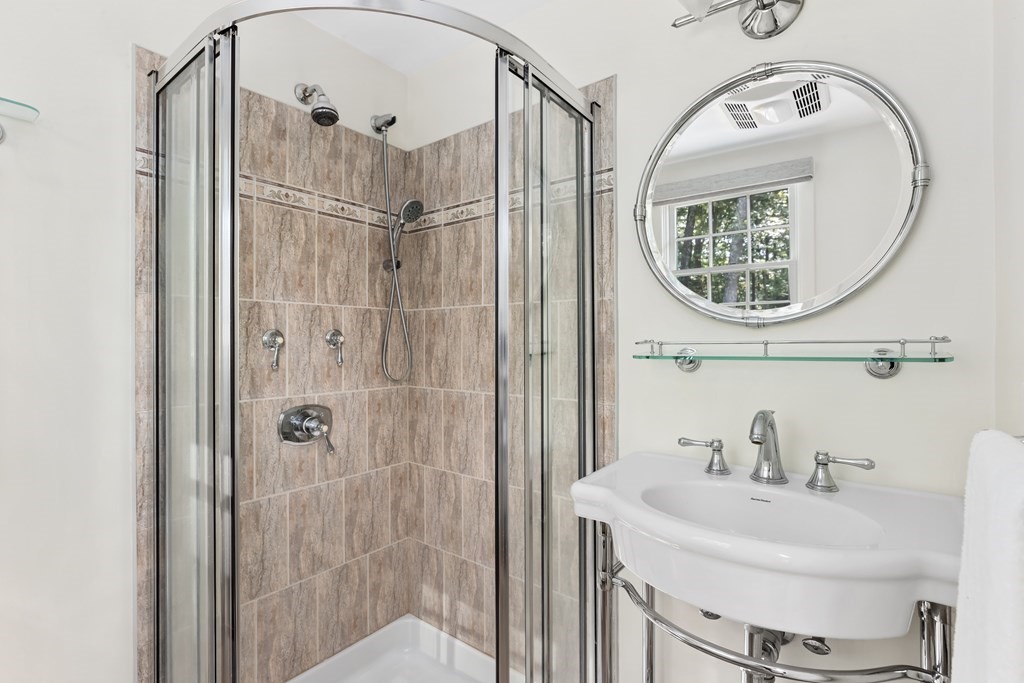 30 Eaton Road Framingham, MA 01701 - Photo 21 of 36 a bathroom with a sink a mirror a vanity and shower