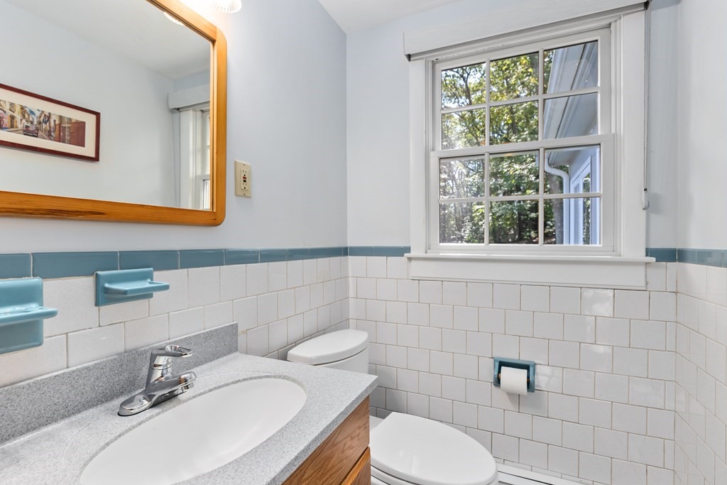 30 Eaton Road Framingham, MA 01701 - Photo 25 of 36 a bathroom with a granite countertop toilet sink and mirror