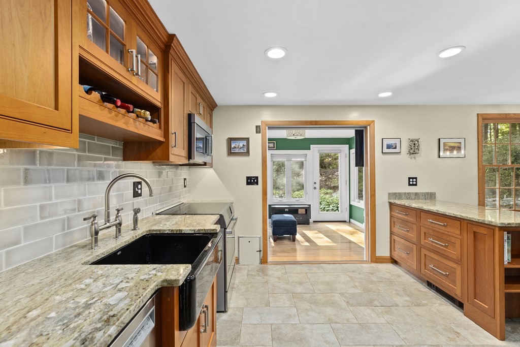 30 Eaton Road Framingham, MA 01701 - Photo 7 of 36 a kitchen with stainless steel appliances granite countertop a stove a sink and a microwave