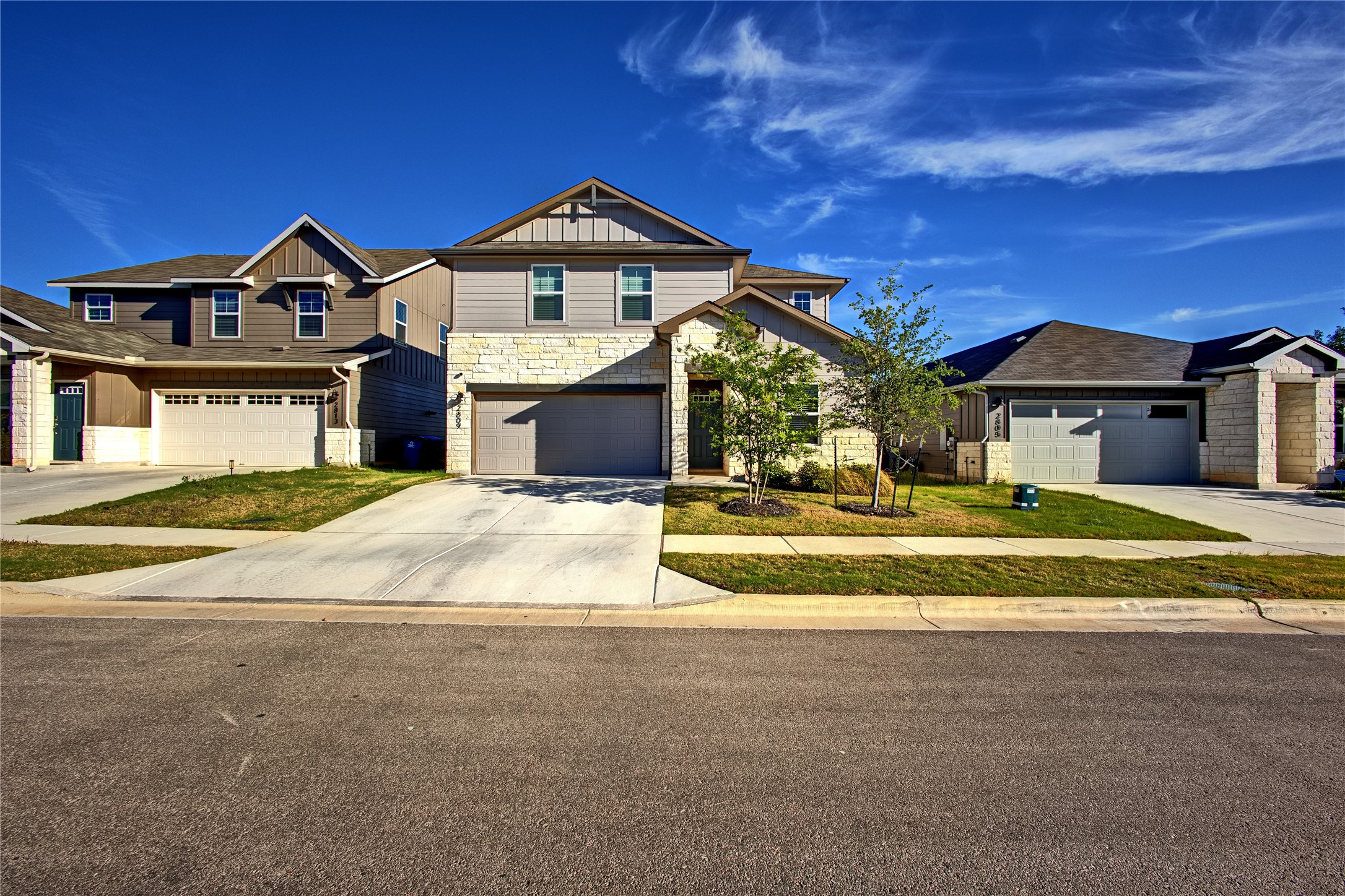 2809 Moyer Lane Round Rock, TX 78665 - Photo 1 of 22 Craftsman-style house featuring stone siding, driveway, an attached garage, and board and batten siding