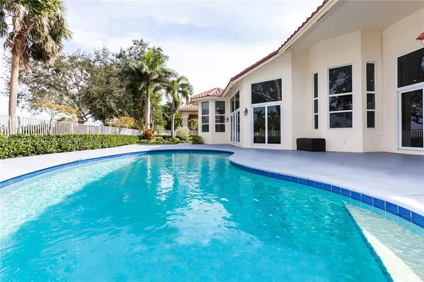 front view of a house with a swimming pool