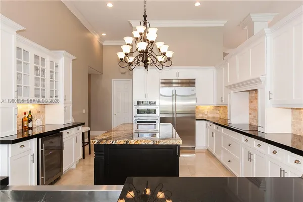 a kitchen with stainless steel appliances granite countertop a sink and a counter