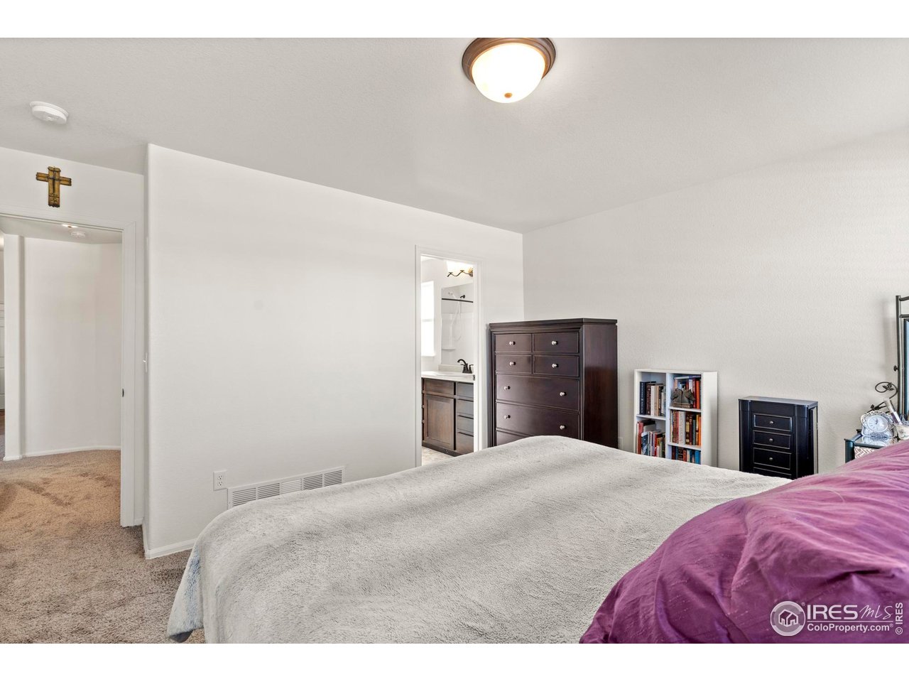 941 Barasingha Street Severance, CO 80550 - Photo 19 of 46 a bedroom with a large bed and dresser