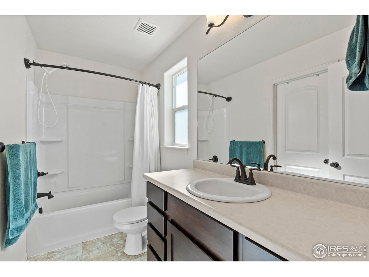 941 Barasingha Street Severance, CO 80550 - Photo 20 of 46 a bathroom with a sink toilet a mirror and shower