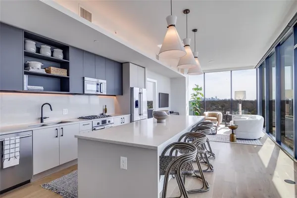 a kitchen with a table chairs stove and cabinets